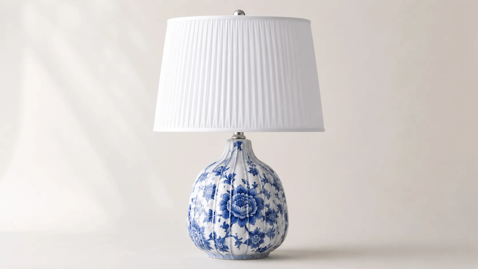 Custom ceramic decor manufacturer example with blue and white floral porcelain-style table lamp and pleated shade